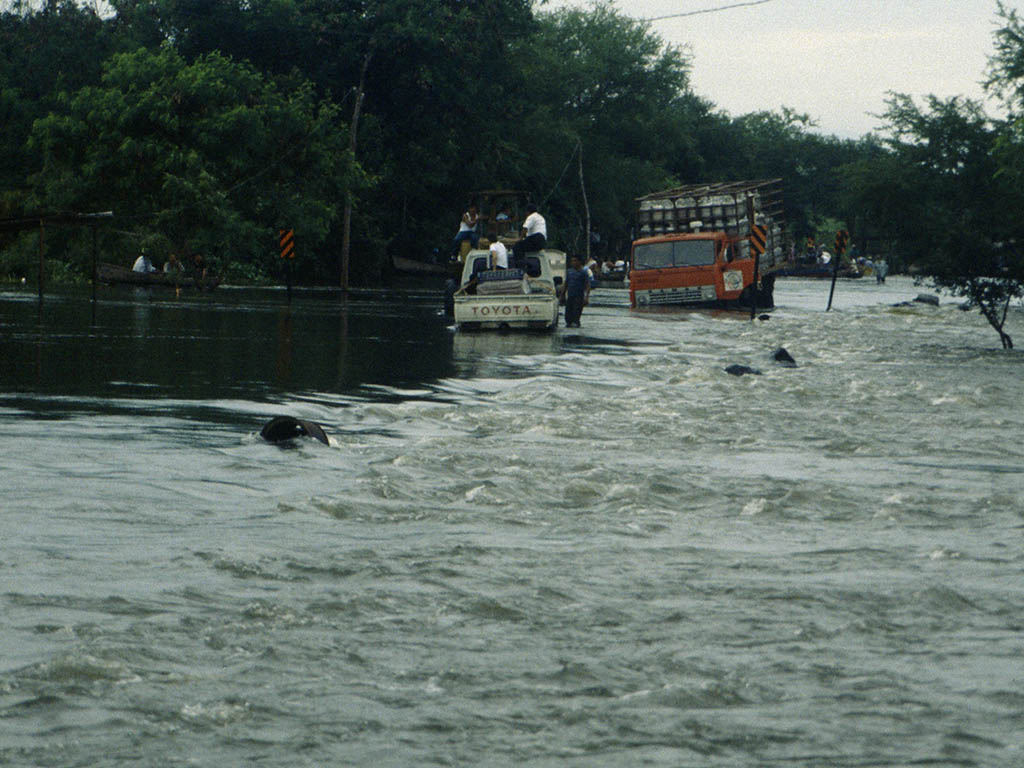 Vehicles are passing the flooded Panamarican Highway in Tipitapa Nicaragua, about one week after Hurricane Mitch.