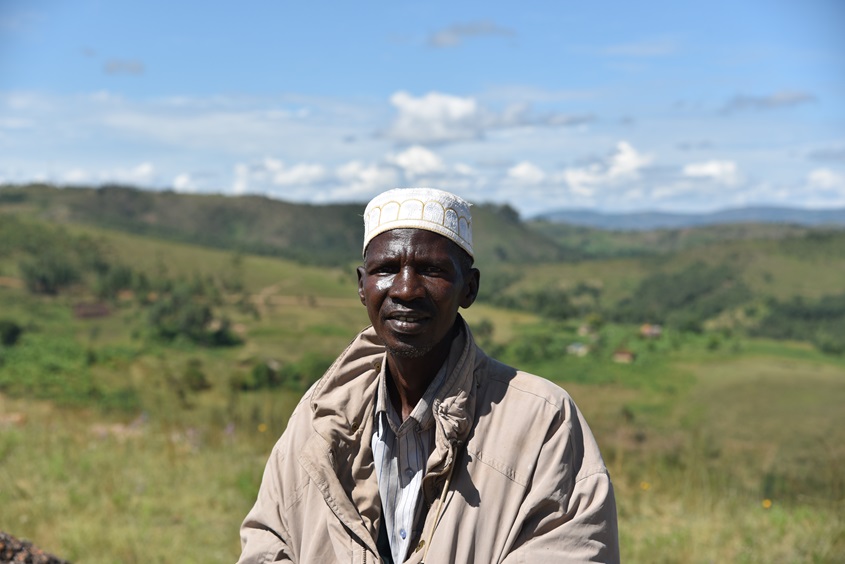 A man standing infront of hills