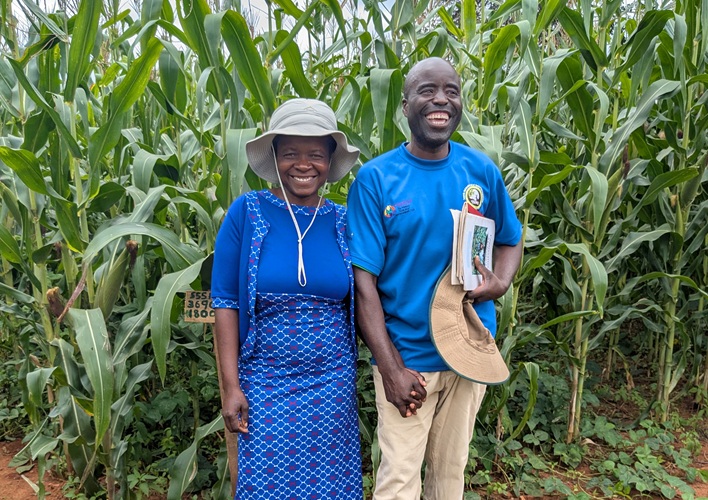 Two people standing in a field.