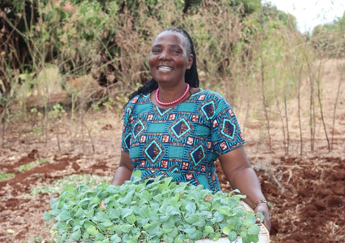 Margaret holding plants from her garden