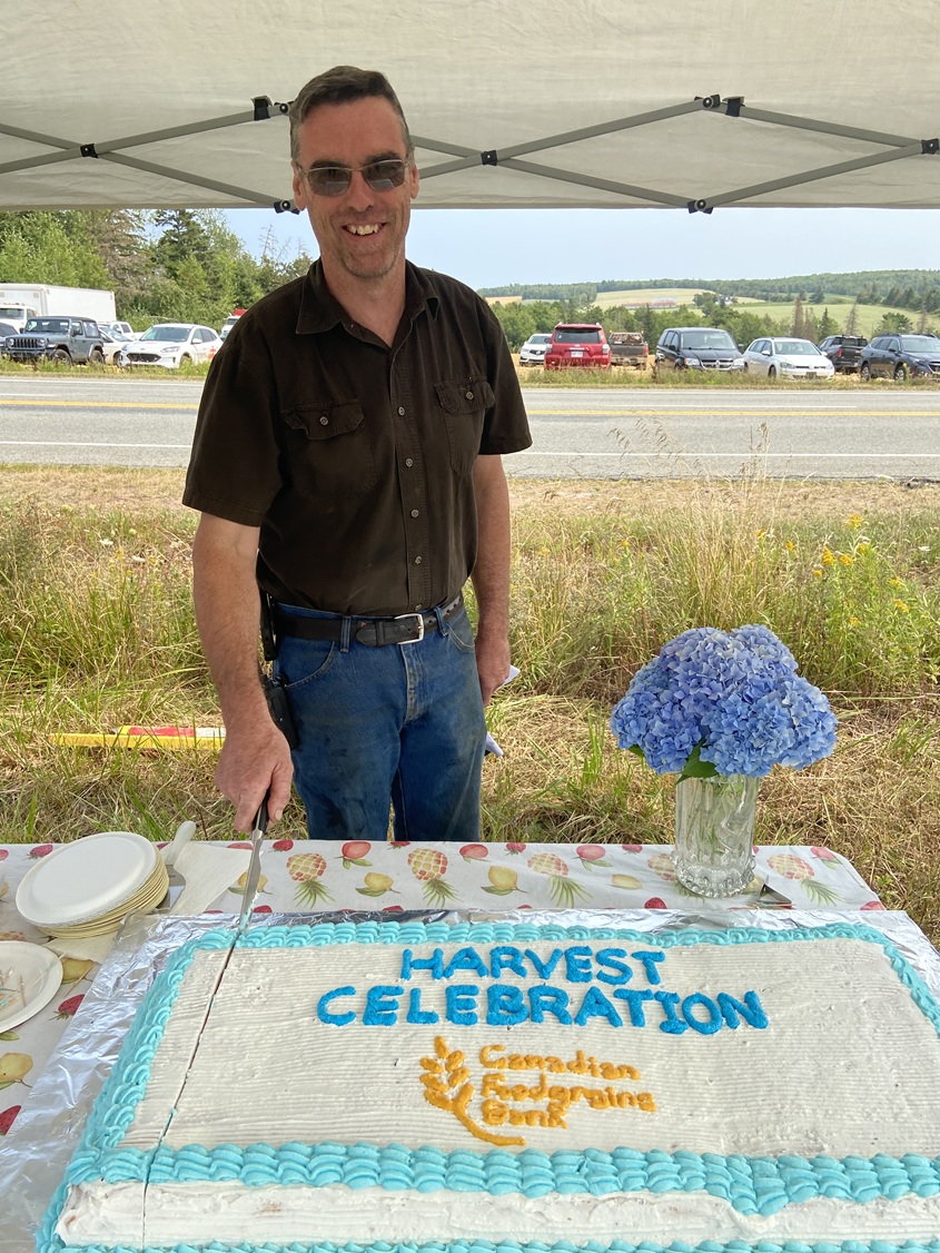Farmer Stephen Visser cutting the cake at a harvest event