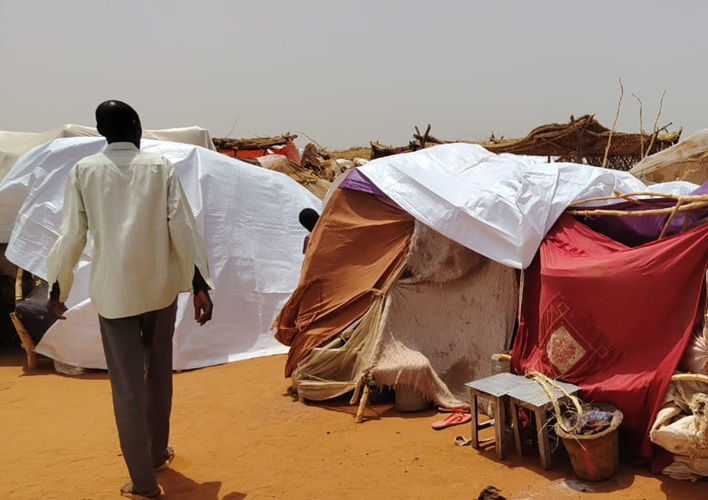 A man walking through his community in Sudan.