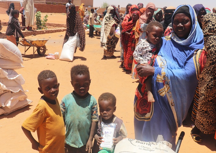Photo shows female participant received her food assistance in distribution site